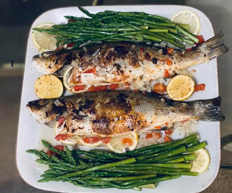 aked Branzino with Lemon and Herbs on a White Plate