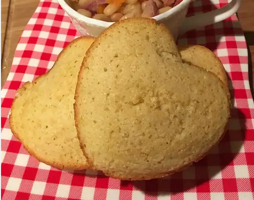 Freshly baked Southern cornbread in a cast iron skillet on a rustic wooden table