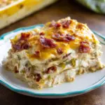 Alt text: A delicious chicken bacon ranch lasagna recipe, showcasing layers of creamy Alfredo sauce, tender chicken pieces, crispy bacon, shredded mozzarella cheese, and lasagna noodles, garnished with fresh parsley.
