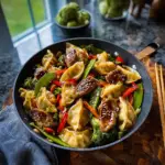 Alt text: "Colorful potsticker stir fry recipe with crispy potstickers, fresh vegetables, and savory sauce served in a large skillet."