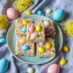 Alt text: "Colorful Easter Egg Rice Krispie Treats arranged on a platter, showcasing the Easter Egg Rice Krispie Treats Recipe with pink, blue, yellow, and green marshmallow-coated cereal shapes."
