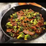 "Delicious beef and broccoli cast iron skillet recipe with tender beef slices and vibrant broccoli florets cooked to perfection in a cast iron skillet."